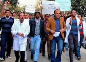 Dr. Taher Mokhtar (second from right, in brown jacket) leads a demonstration during the January 2014 doctor's strike